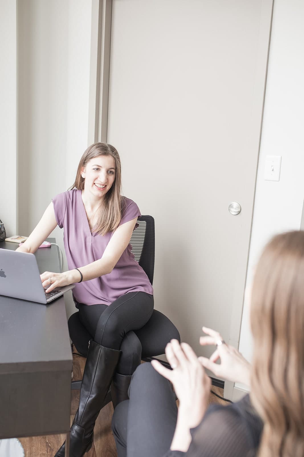 Practitioner talking with a patient in a bright consultation room